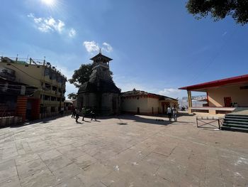 Statue amidst buildings against sky