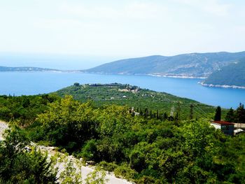 Scenic view of sea and mountains against sky