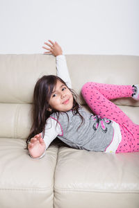 Portrait of a smiling girl on sofa at home