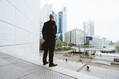 Rear view of man standing in city