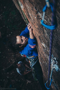 High angle view of man by rope on tree