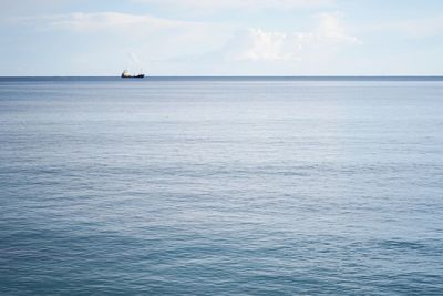 Sailboat sailing on sea against sky