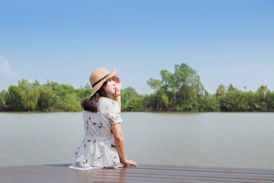 Full length of woman in lake against clear sky