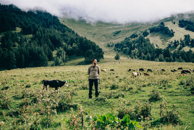 Man standing on grassy mountain