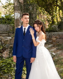Portrait of bride standing in park