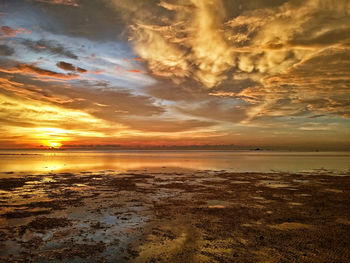 Scenic view of sea against dramatic sky