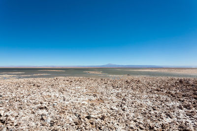 Scenic view of desert against clear blue sky