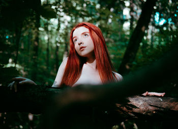 Portrait of young woman in forest