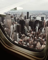 High angle view of modern buildings in city against sky
