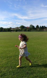 Full length of toddler running on field