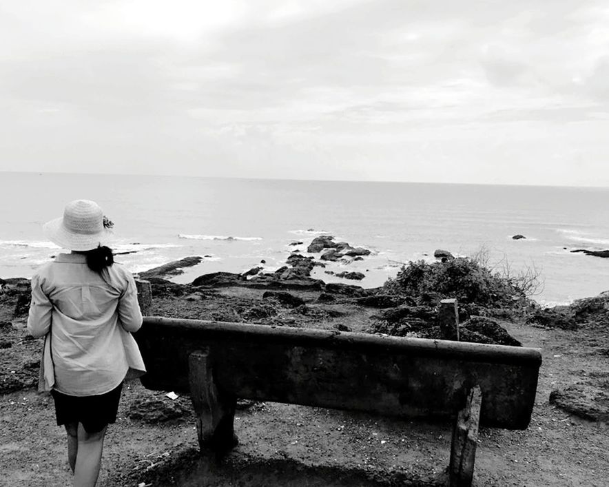 rear view, sea, water, real people, sky, leisure activity, lifestyles, horizon over water, one person, horizon, nature, scenics - nature, beauty in nature, casual clothing, day, standing, women, land, outdoors, looking at view, hood - clothing