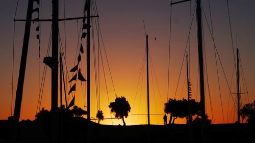 Silhouette sailboats mast against sky during sunset at st martin de re