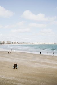 People on beach against sky