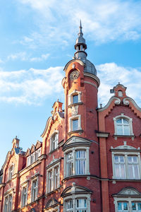 The building of the town hall from 1904. red brick facade. beautiful blue sky.