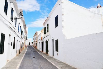 Street amidst buildings against sky