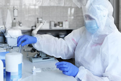 Midsection of dentist examining patient in laboratory