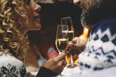 Midsection of couple holding champagne flutes