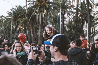 People photographing on palm trees