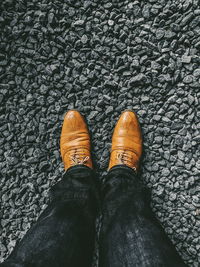 Low section of person standing on shoes