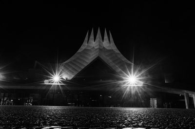 Low angle view of illuminated building against sky at night