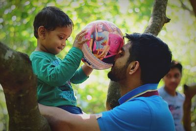 Full length portrait of friends on tree