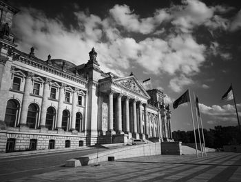 Low angle view of building against cloudy sky