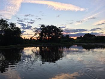 Scenic view of lake against sky at sunset