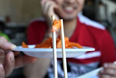 Close-up of man eating food