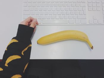 Close-up high angle view of keyboard and banana