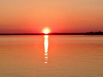 Scenic view of sea against romantic sky at sunset