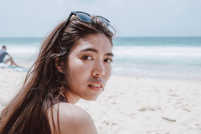 Portrait of mid adult woman standing at beach