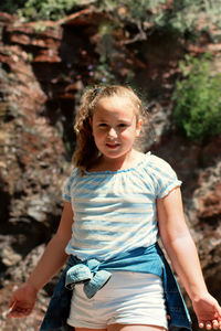 Portrait of smiling girl standing outdoors