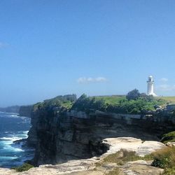 Scenic view of cliff by sea