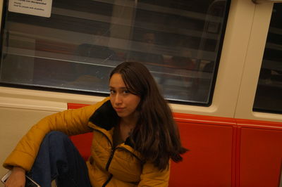 Young woman looking through train window