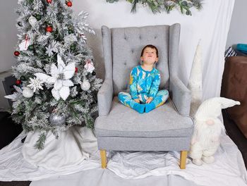 Portrait of woman sitting on sofa at home