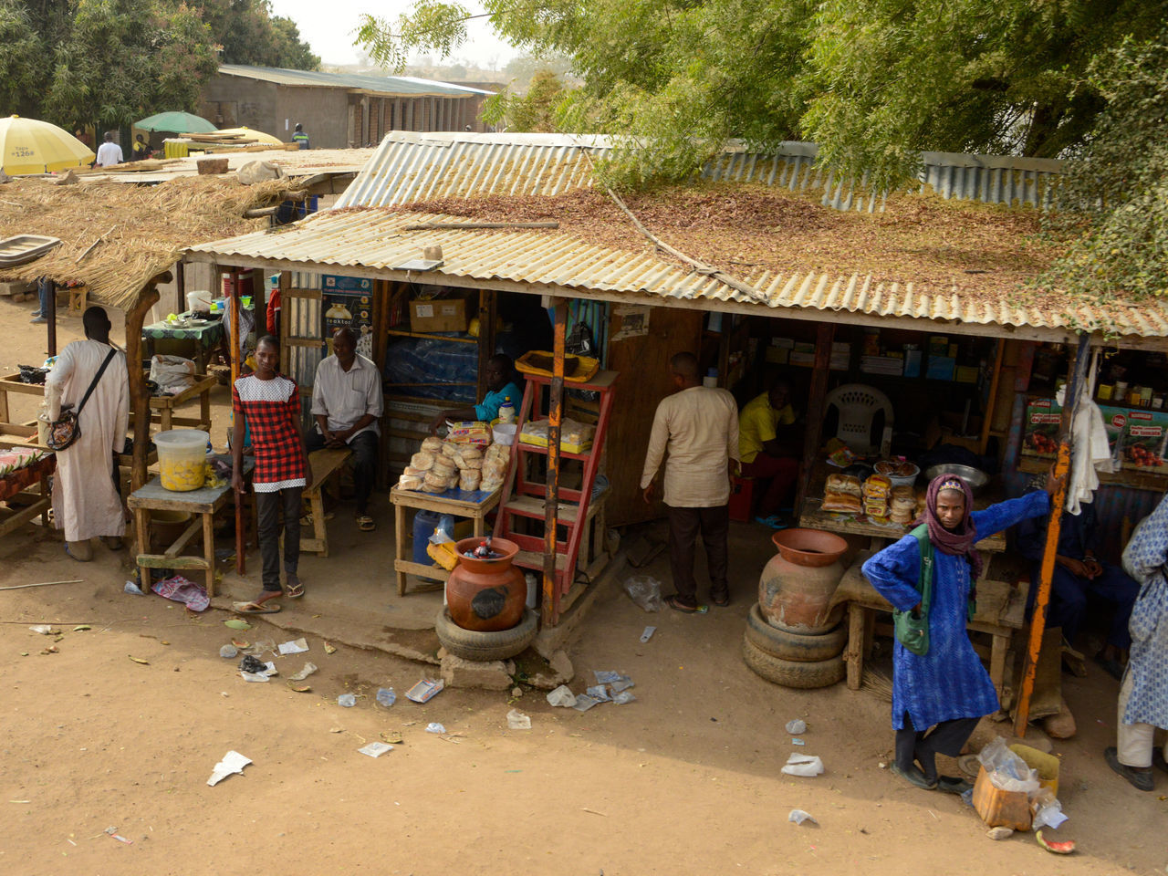 PEOPLE WALKING ON STREET AT MARKET STALL