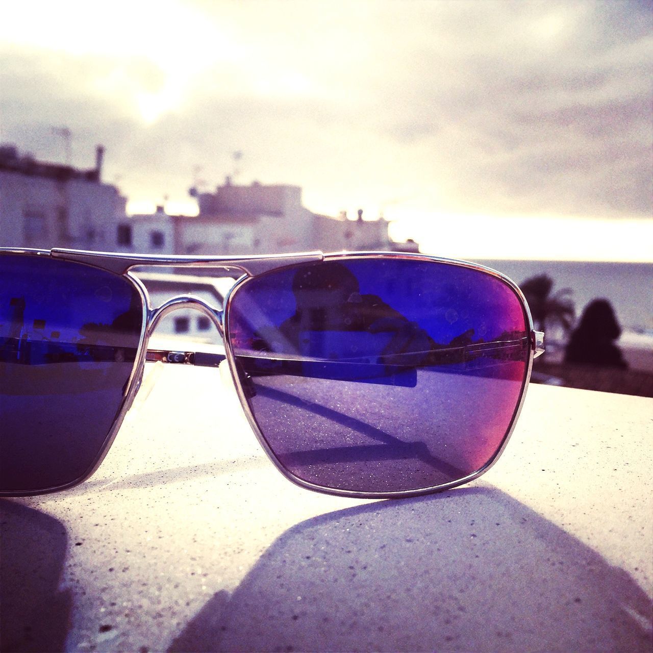 REFLECTION OF SUNGLASSES ON WATER