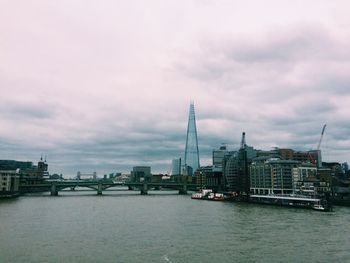 Boats in river with buildings in background