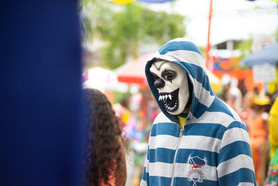 People wearing horror masks are seen playing during the carnival