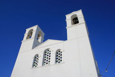 Low angle view of building against clear blue sky