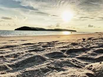 Scenic view of beach against sky during sunset