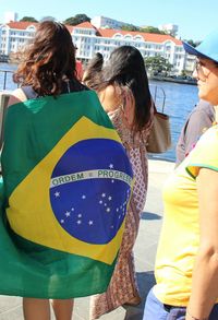 Rear view of woman standing by railing