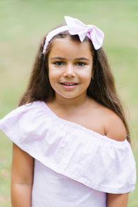 Portrait of a beautiful smiling baby girl in a soft pink dress person