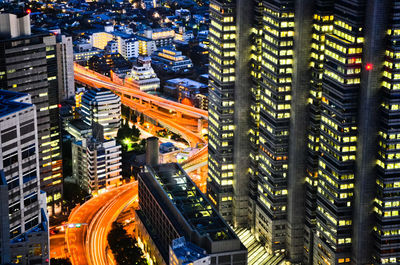 Aerial view of city street and buildings at night