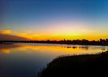 Scenic view of lake at sunset