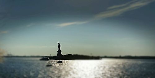 Silhouette ship in sea against sky