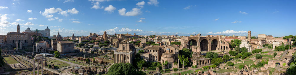 Panoramic view of buildings in city against sky