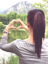 Portrait of woman holding heart shape