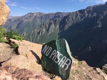 High angle view of text on rock against sky