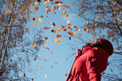 Low angle view of woman standing against sky